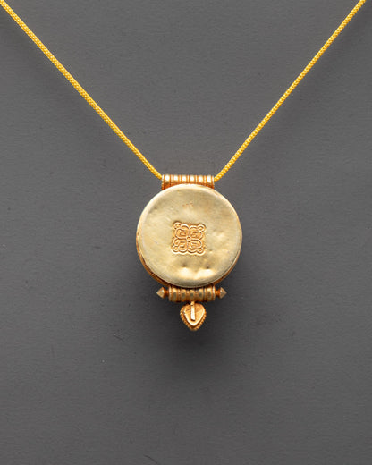 Back view of sacred Buddhist locket showcasing detailed craftsmanship and gold plating


