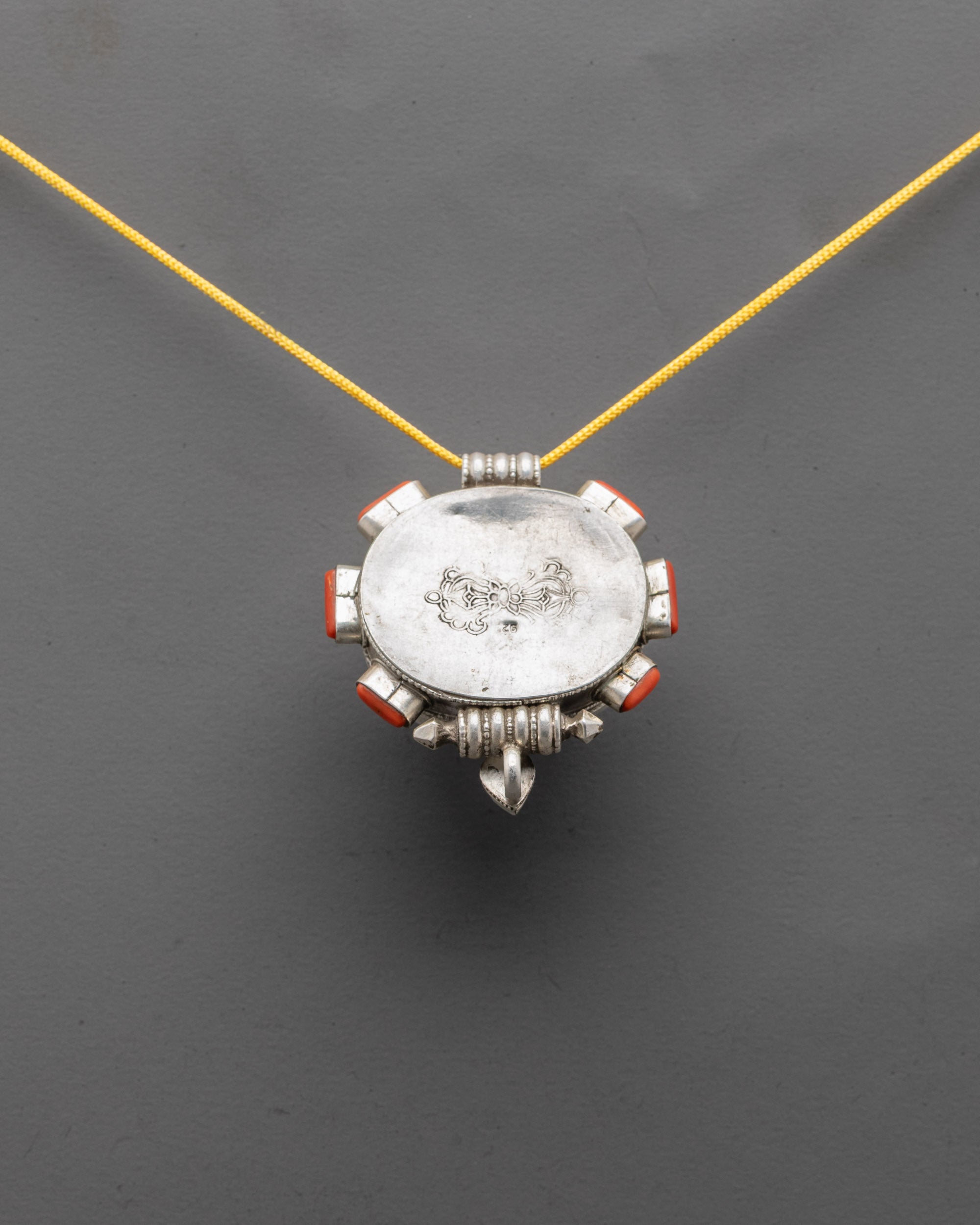 Back view of silver body with filigree design on Red Coral Stone Pendant
