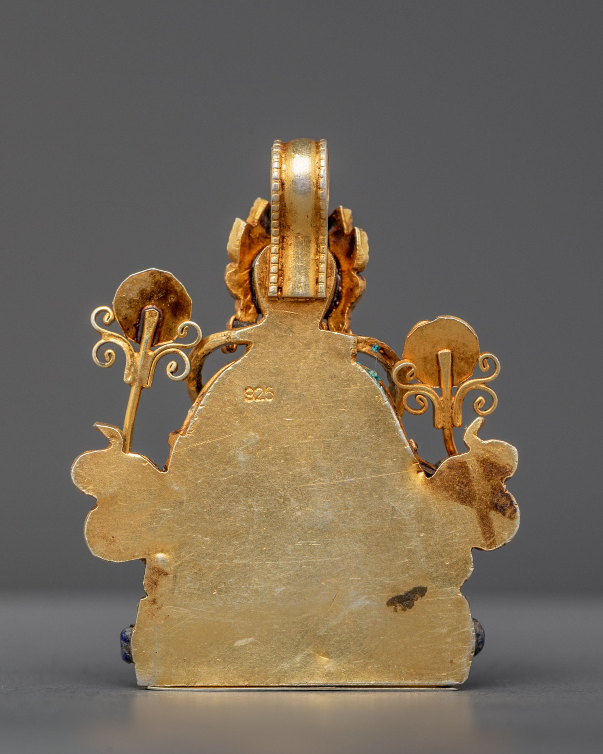 Back view of spiritual Green Tara Locket with intricate gold-gilded filigree work
