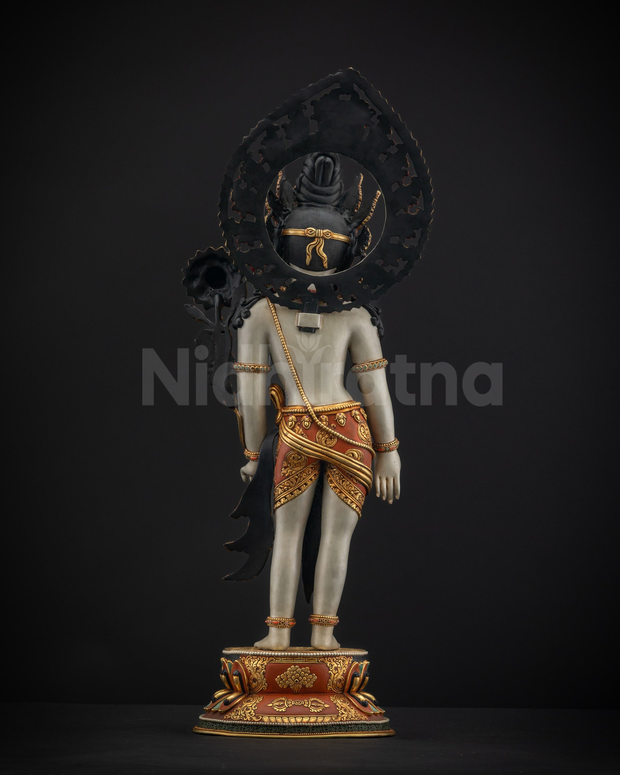 Back view of standing Padmapani showing an intricate hand-carved floral halo and lower garment