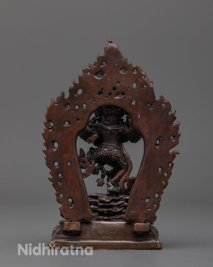 Back view of the oxidized copper Hevajra sculpture featuring flame-like details