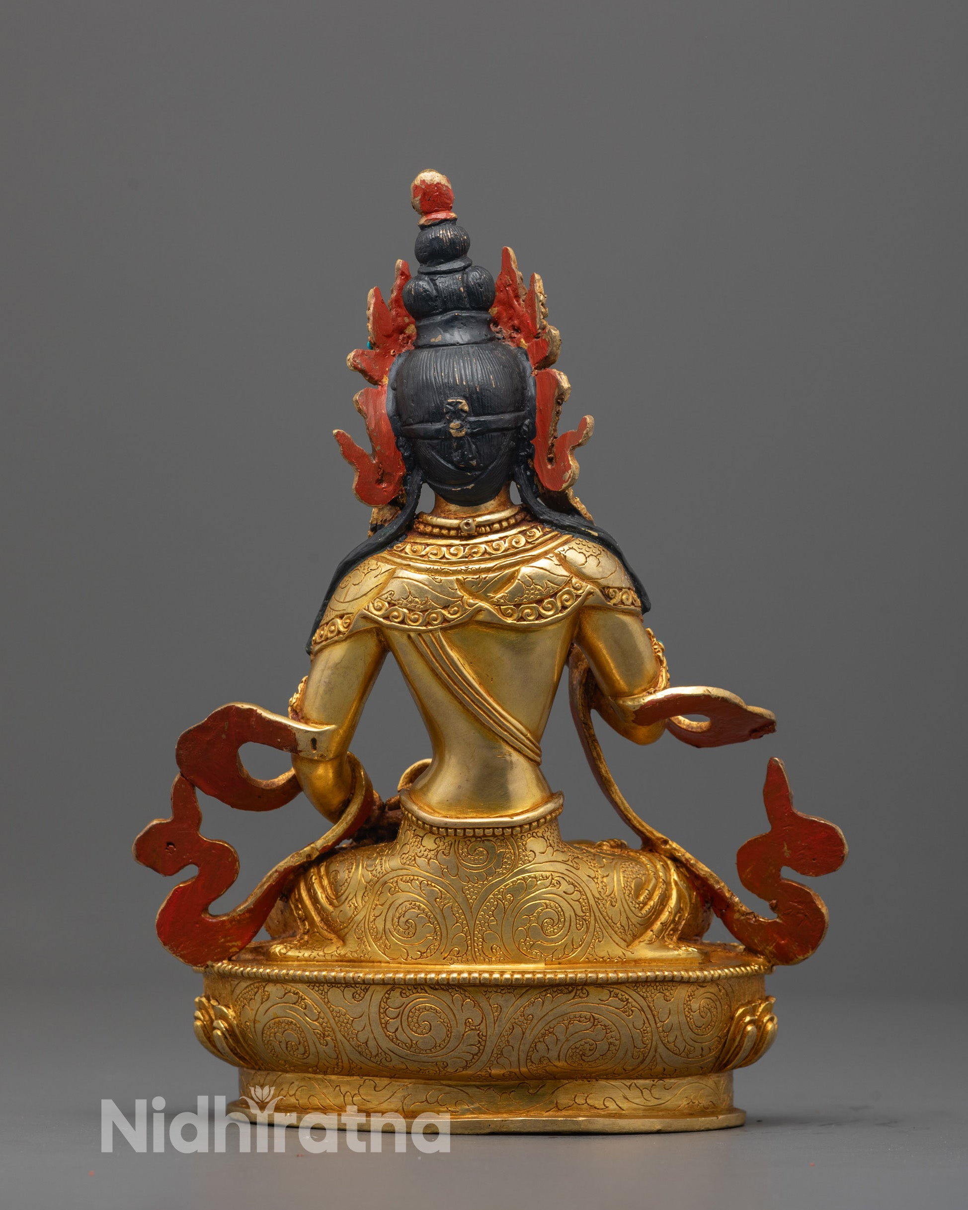 Back view of the statue revealing the consecration chamber and the luminous gold finish