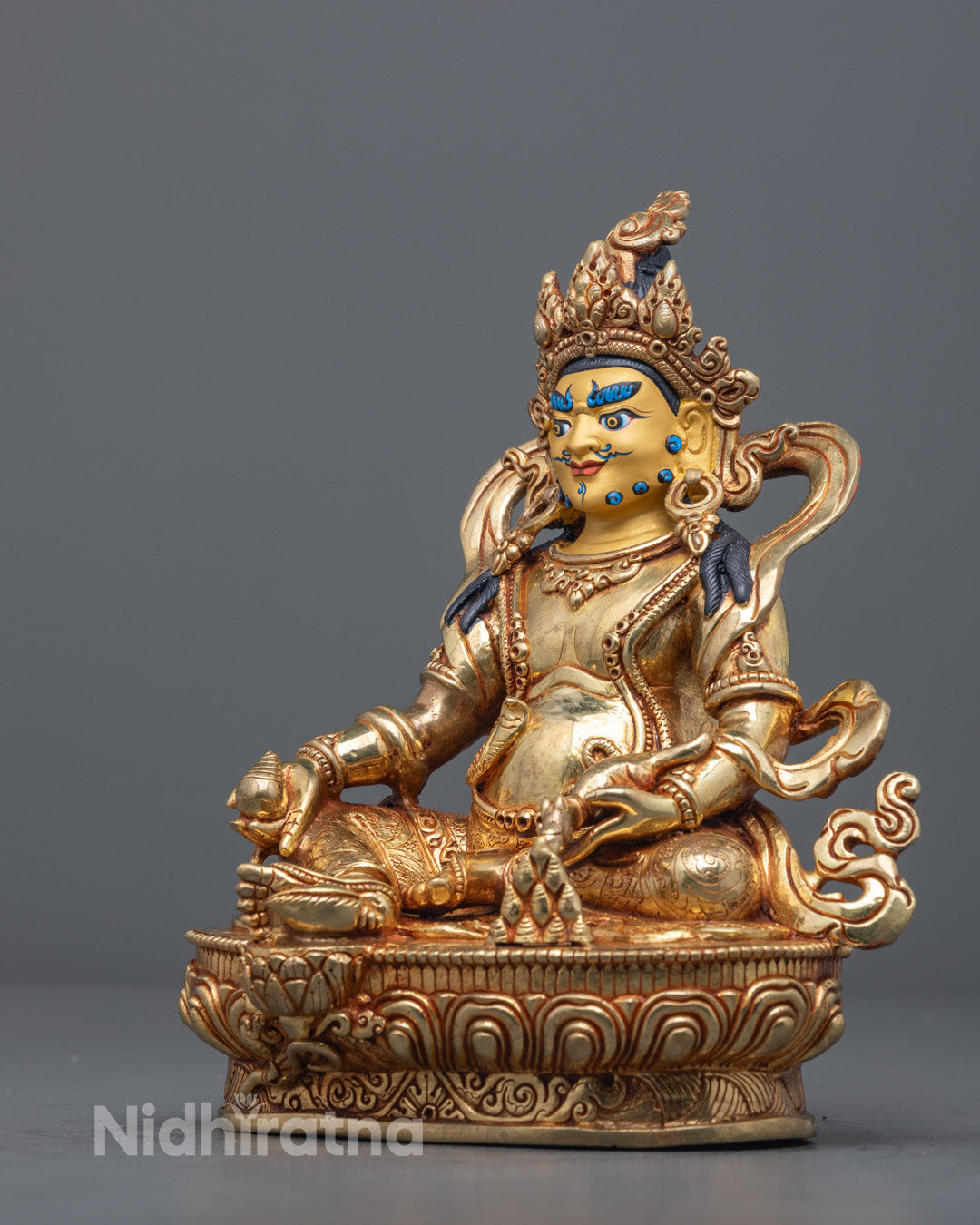 traditional Dzambhala statue highlighting lost wax detailing and vibrant acrylic colors