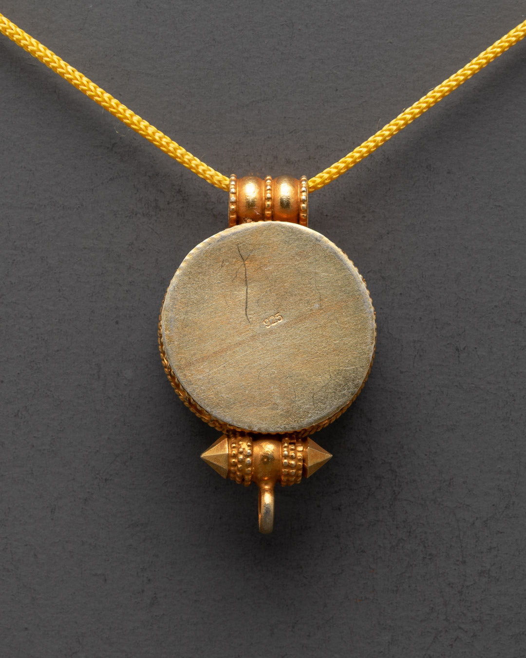 Back view of traditional Tibetan Treasure Vase Locket carved by master artisans from Nepal