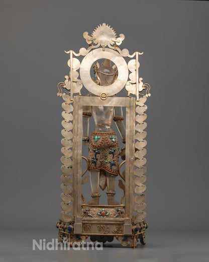 Back view of traditionally handcrafted Lokeshwor statue from Nepal, emphasizing copper texture and artisan stonework.