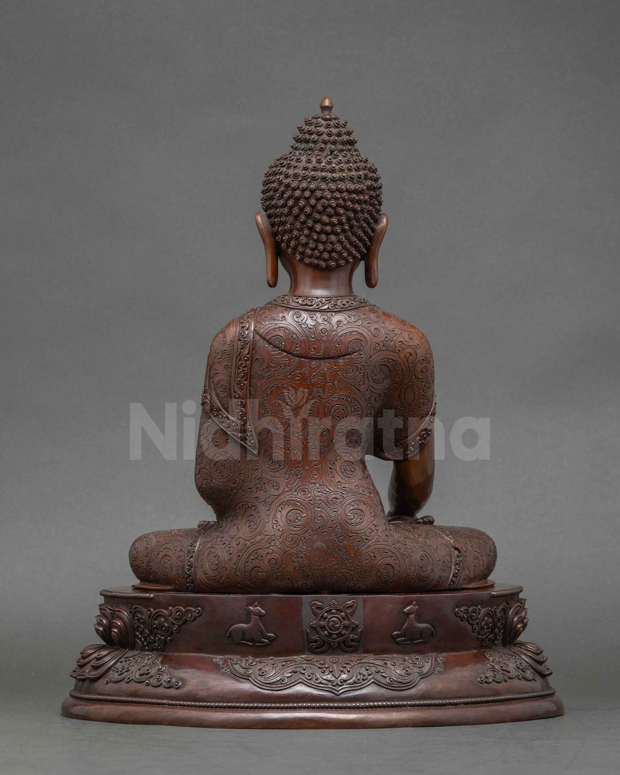 Back view of trio Buddha statues on altar, crafted by skilled Newari artisans from Patan, Nepal