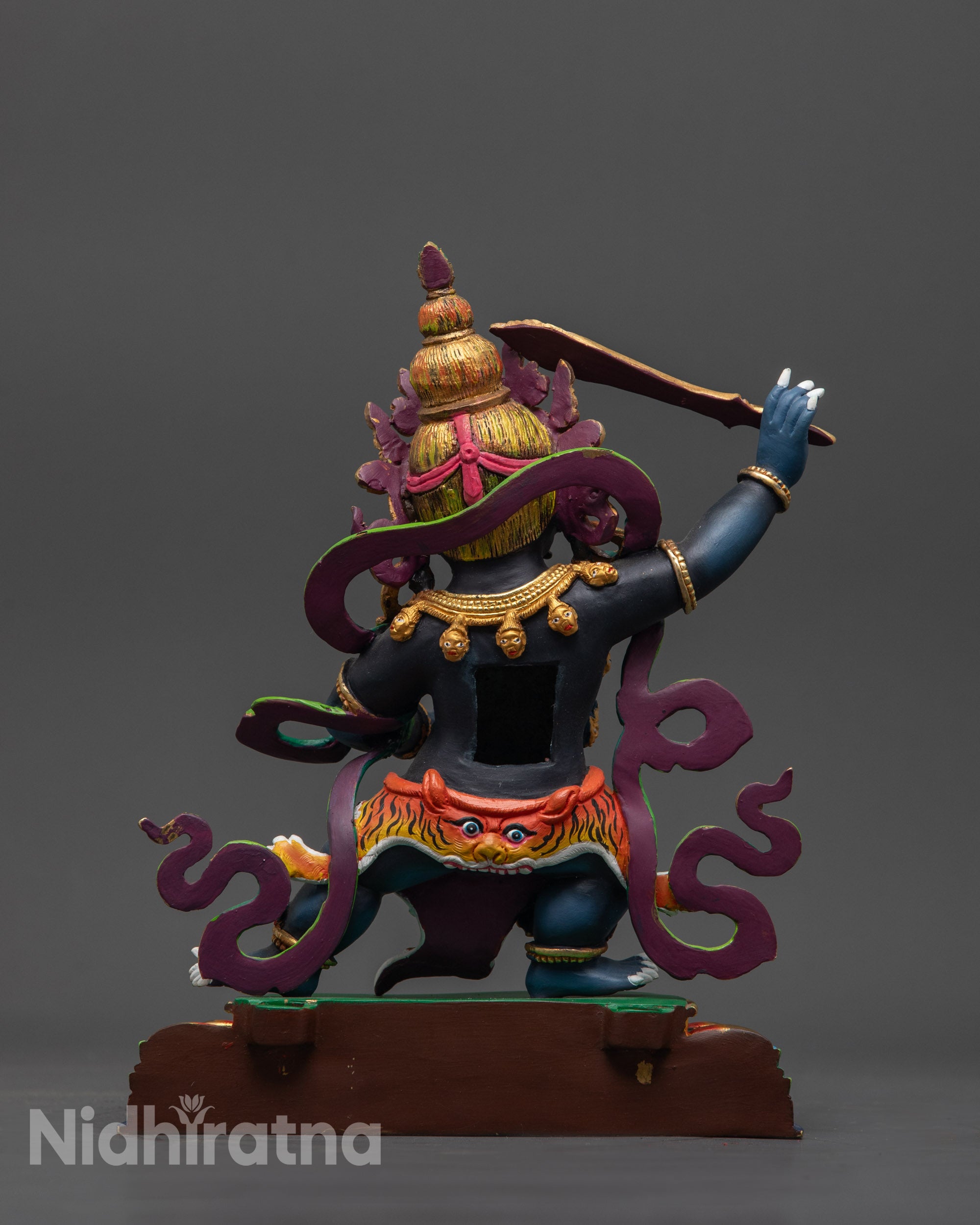 Back view of wrathful Manjushri sculpture showing intricate carvings and gold-plated finish