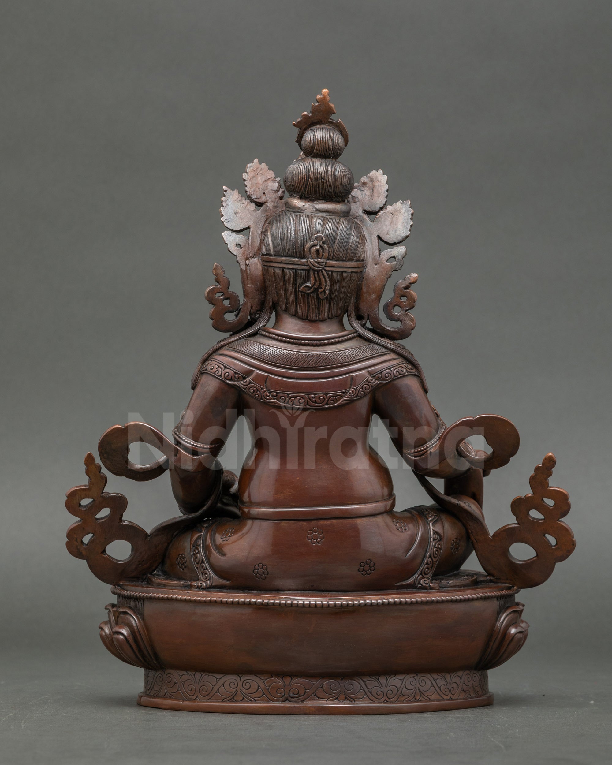 Back view oxidized Dzambhala figure on detailed lotus base, meditation and spiritual décor