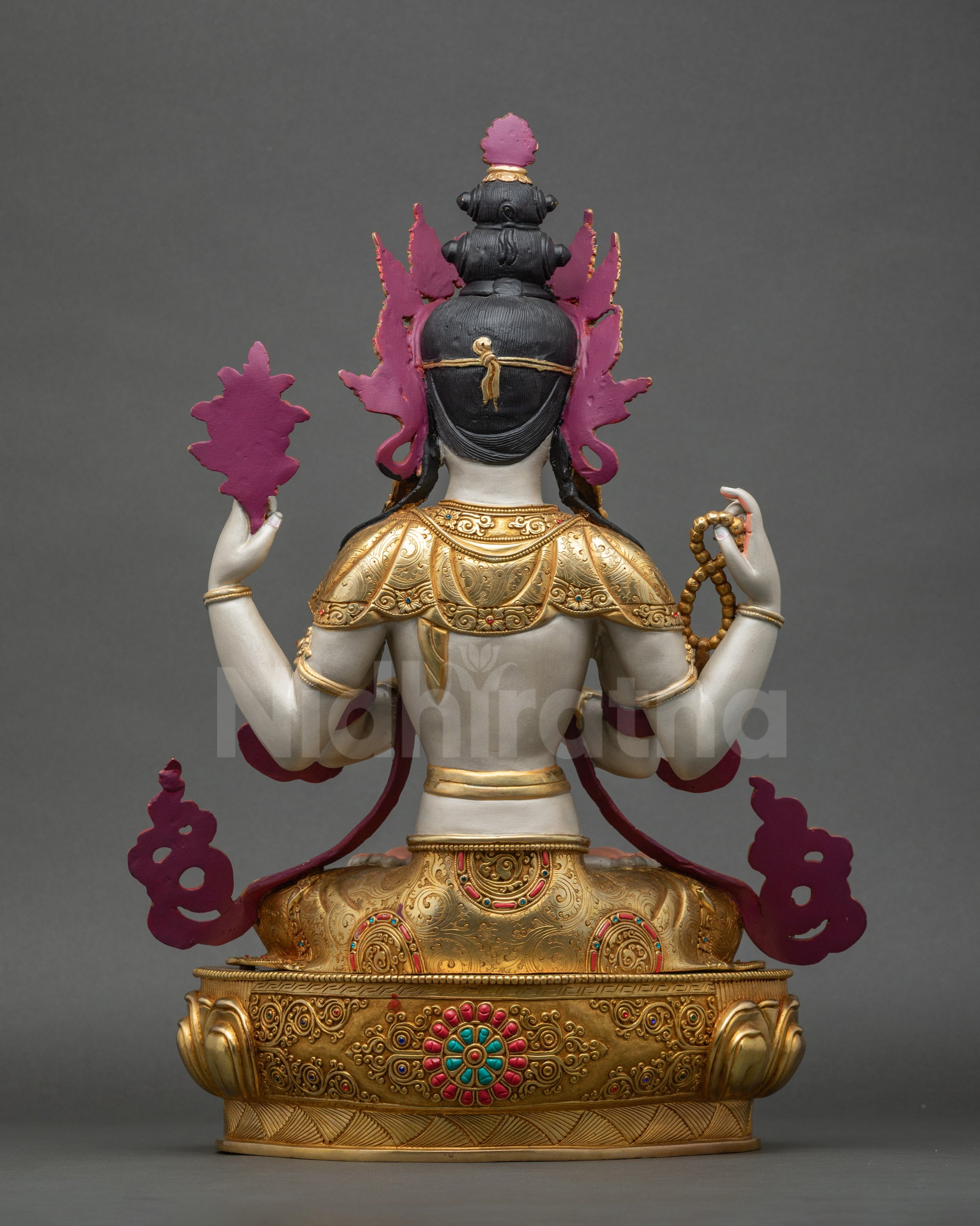 Back view showing carved swirling robe patterns and detailed artisan craftsmanship
