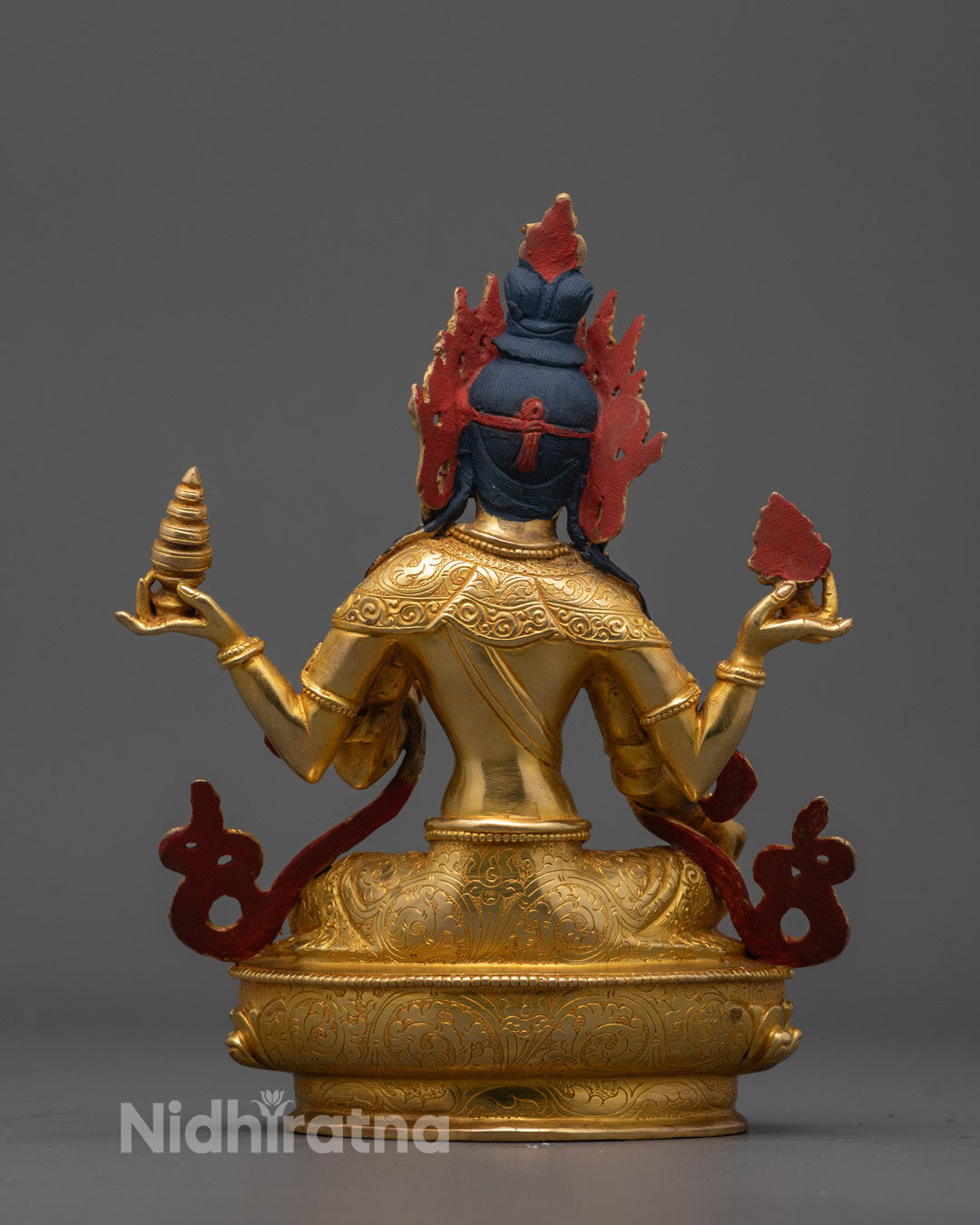 Back view showing detailed carvings on Goddess Laxmi statue's copper base and robe