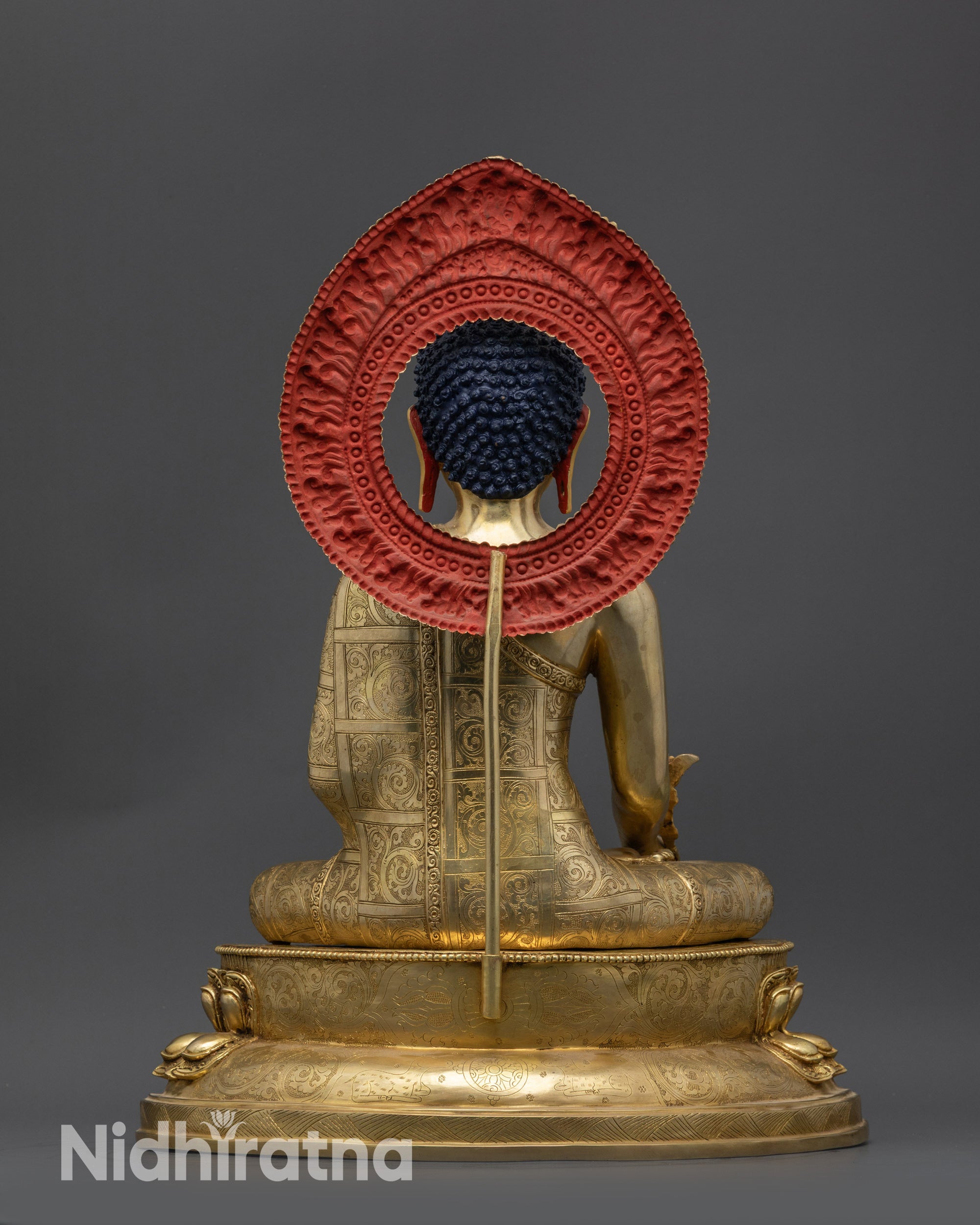 Back view showing lotus seat, dharma wheel, and detailed Vajra carvings