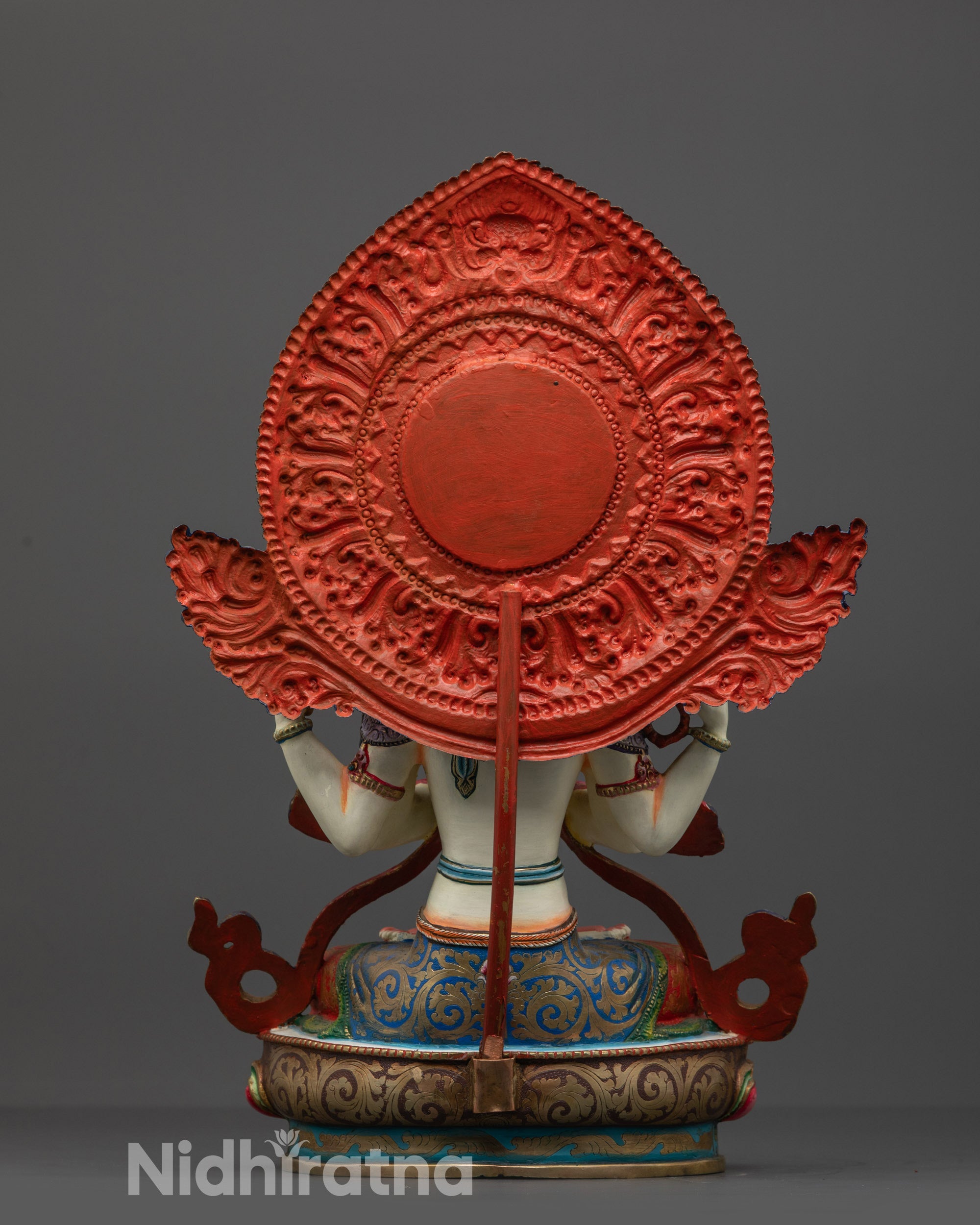 Back view showing the intricate carvings and majestic halo of the copper statue.
