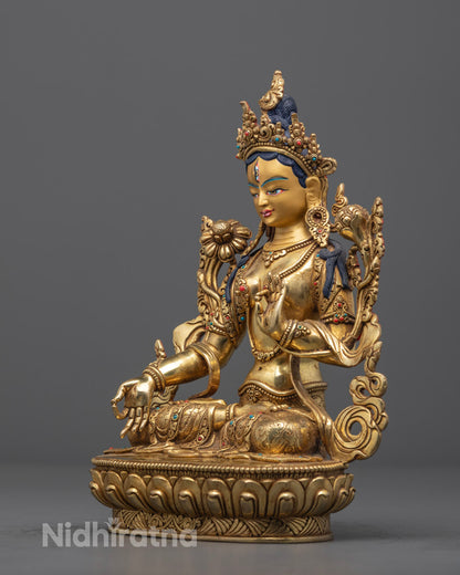 Beautiful Green Tara statue carved from stone, seated in half-lotus posture on a lotus throne, featuring semi-precious stone inlays and a hollow chamber for consecration, handmade in Nepal.