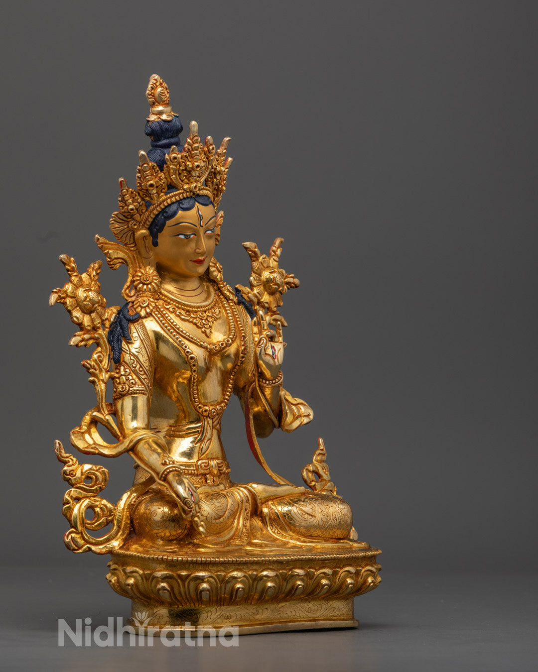 Beautifully colored White Tara Buddhist statue adorned with acrylic paint and fine gold accents