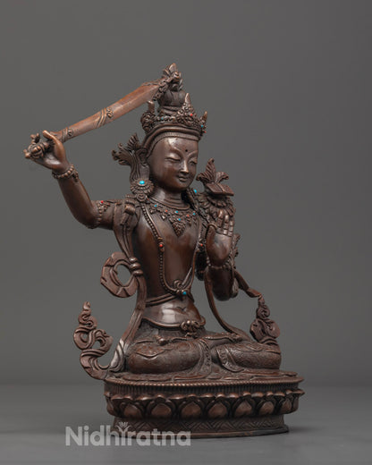 Beautifully painted oxidized Manjushri statue featuring uptala flowers and lotus throne with precise carvings