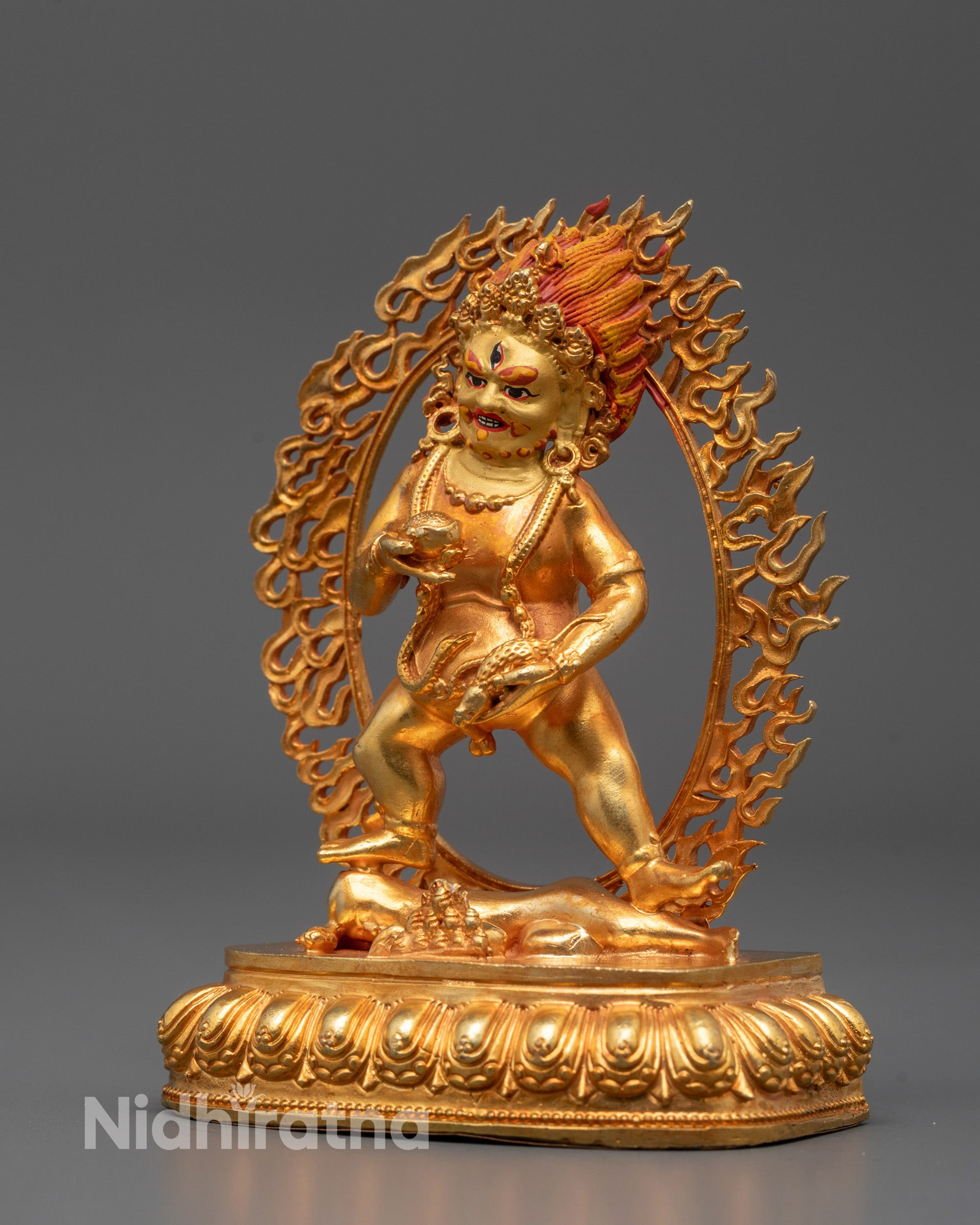 Black Dzambhala deity statue showing intricate details of face, halo