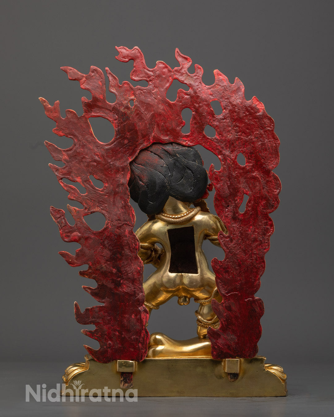 Black Dzambhala deity statue surrounded by black sesame seed offerings, incense, and water, representing purification of financial and spiritual obstacles.