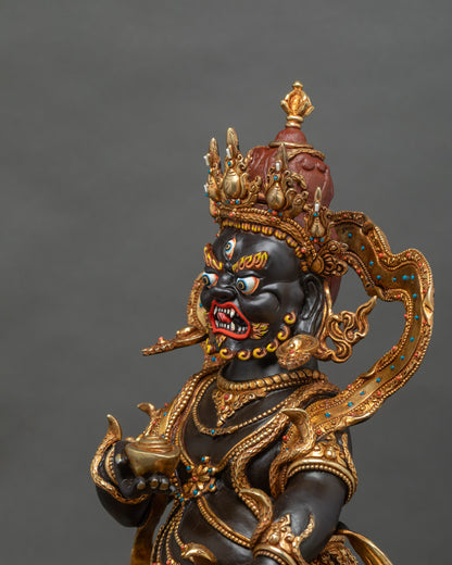 Black Dzambhala statue face, semi-wrathful expression with flaming brows