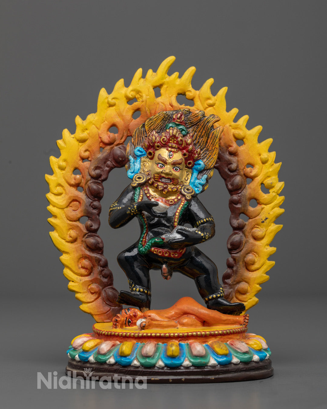 Black Dzambhala statue handcrafted using traditional lost wax method with 24k gold plated face and vibrant acrylic colors
