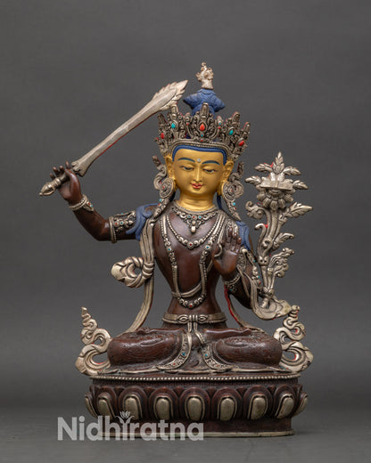 Bodhisattva Manjushri statue on lotus pedestal, oxidized copper with gold face