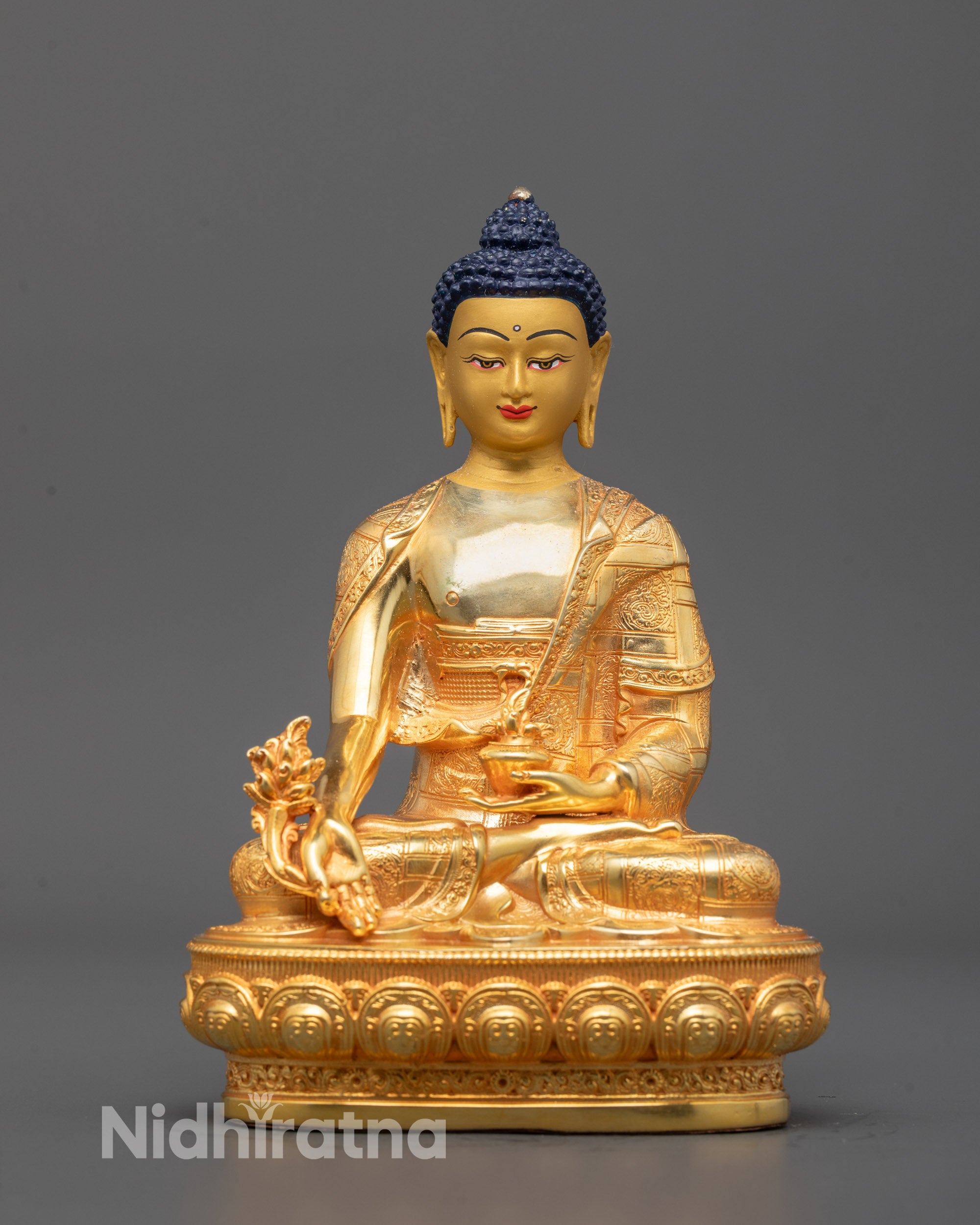 Machine-made Medicine Buddha Statue from Nepal seated on a lotus base holding monk’s bowl 