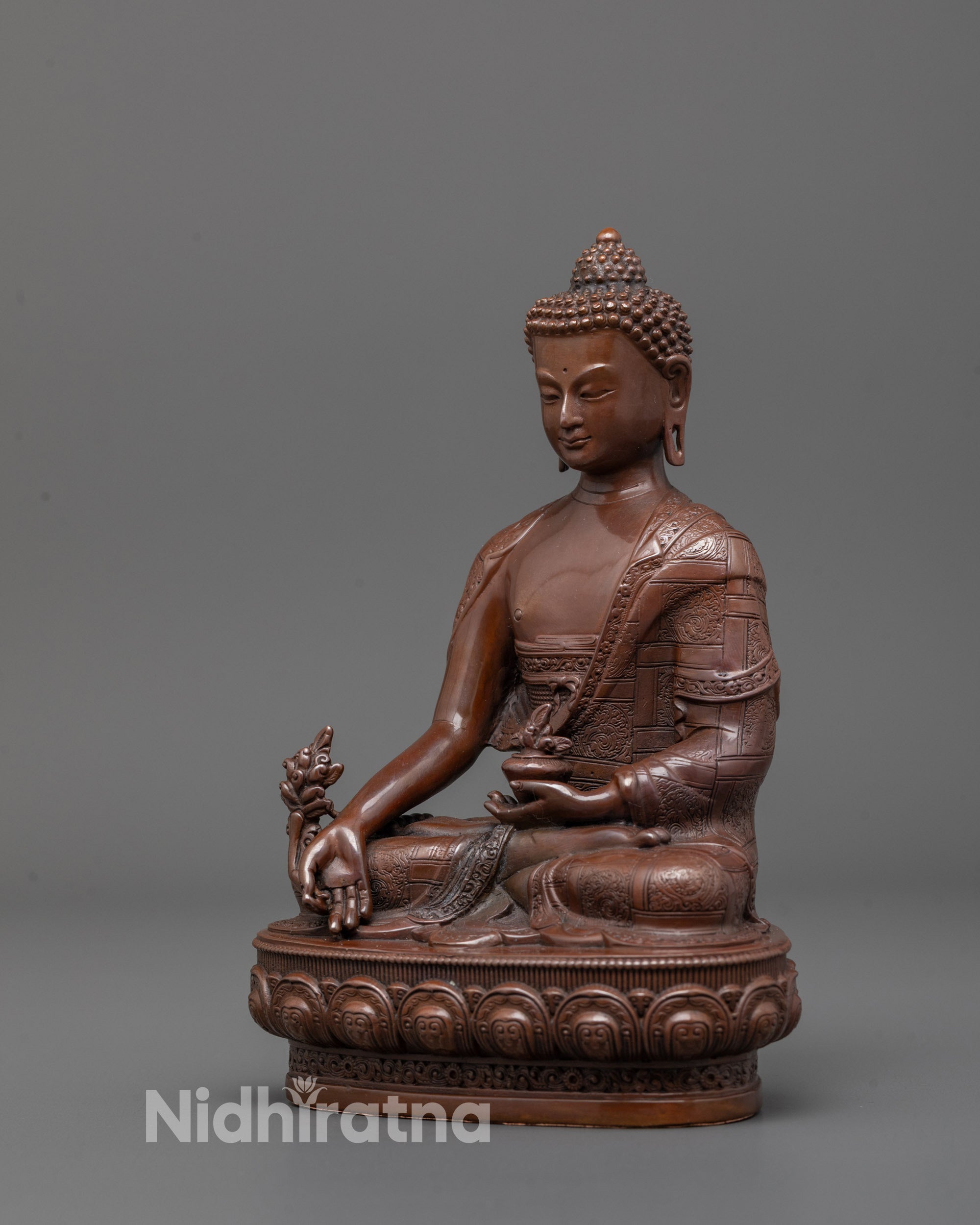 Full view of Medicine Buddha statue placed on meditation altar showcasing intricate lotus base