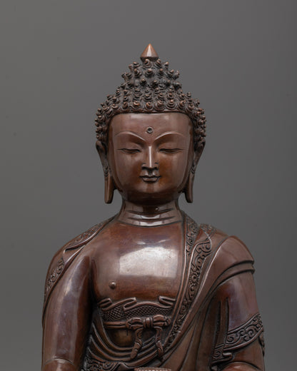 Close up of Shakyamuni Buddha statue face with oxidized copper and monk’s robe details