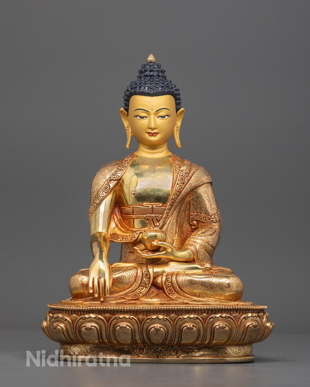 Front angle of gold-gilded Shakyamuni Buddha statue in Bhumisparsha Mudra on lotus throne