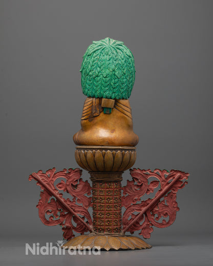 Back view of Mitrugpa statue highlighting painted acrylic colors and oxidized copper finish