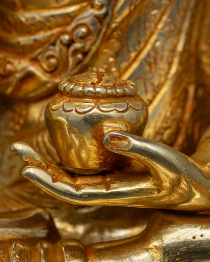 Buddha holding monk’s bowl, seated on lotus throne, traditional Newari lost-wax sculpture