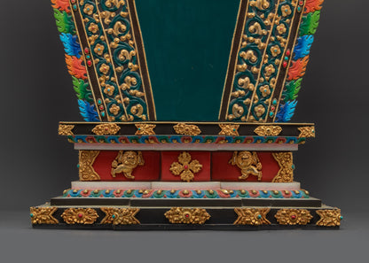 Buddhist statue throne side close up showing lion guardian and gold surface
