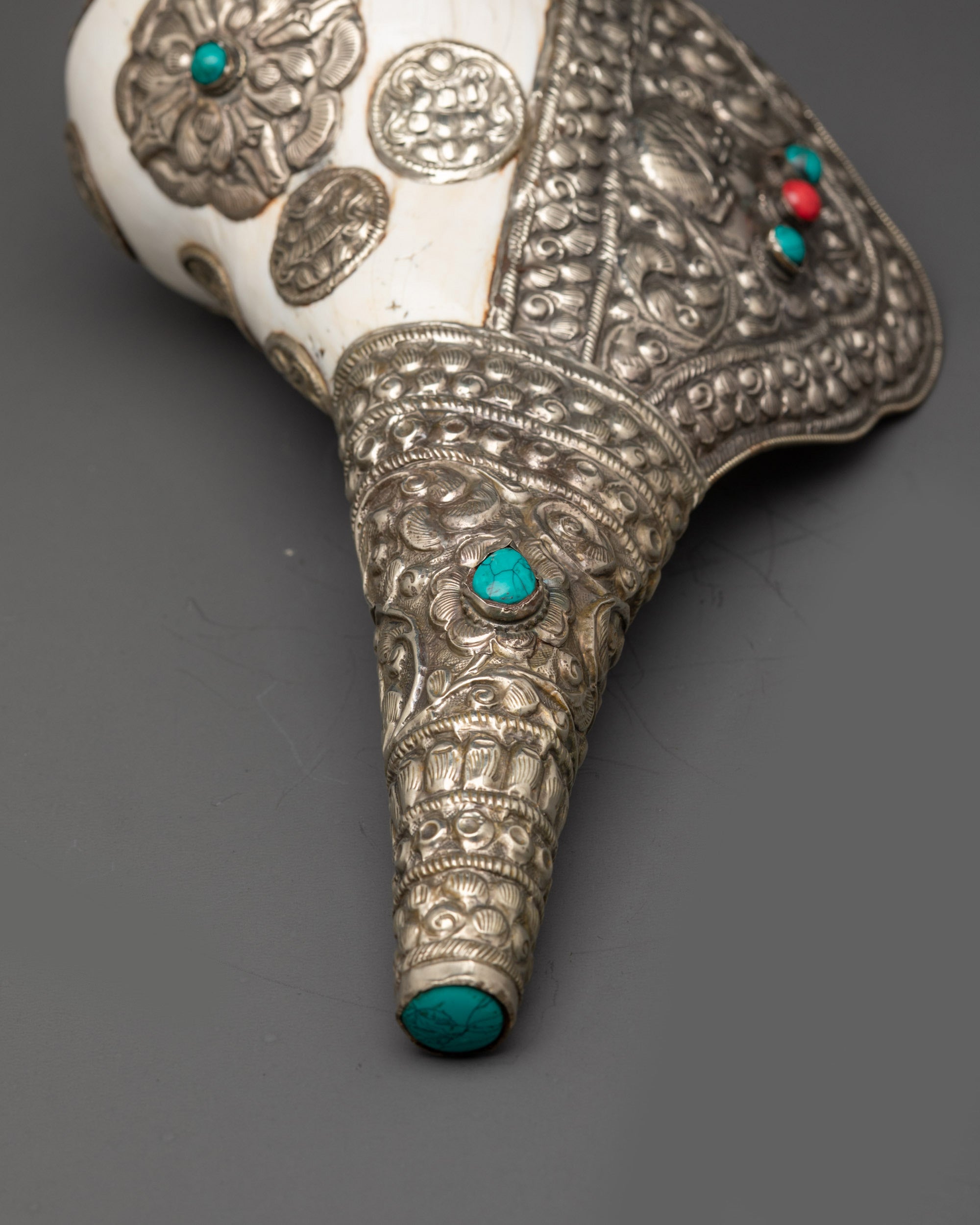 Ceremonial conch shell with semi-precious stone inlays and intricate silver design