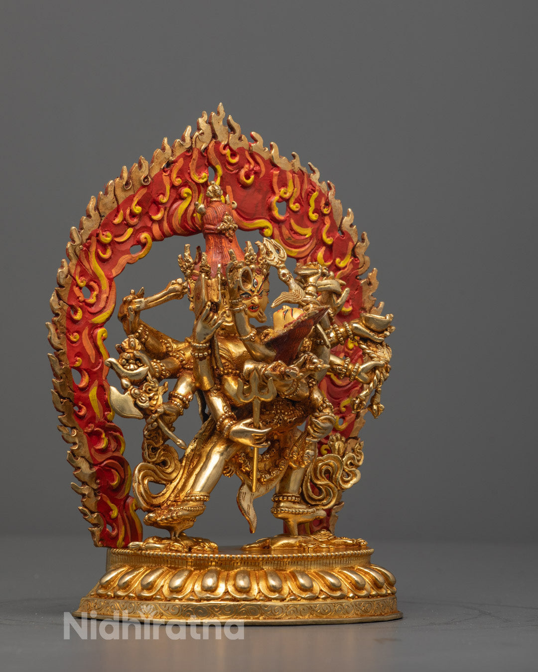 Side view of Chakrasamvara Yab-Yum statue with blazing halo and intricate carvings