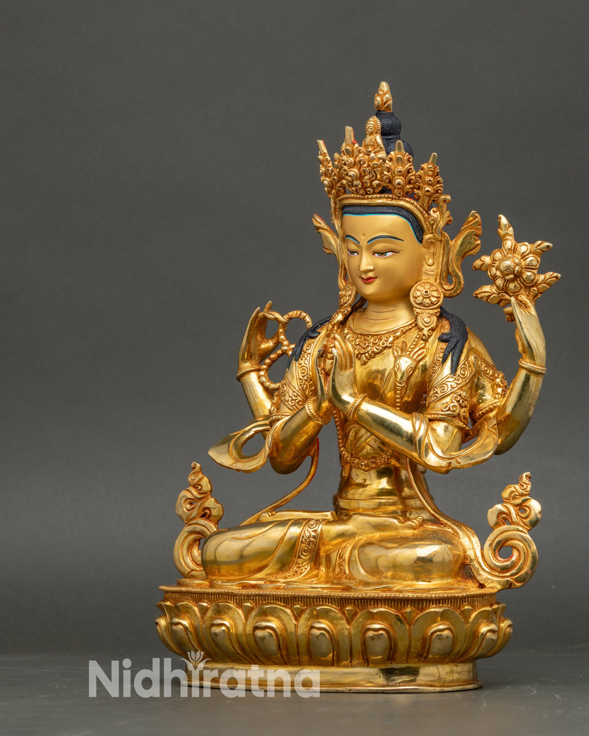 Chenrezig Bodhisattva statue seated on lotus throne, four arms holding sacred attributes