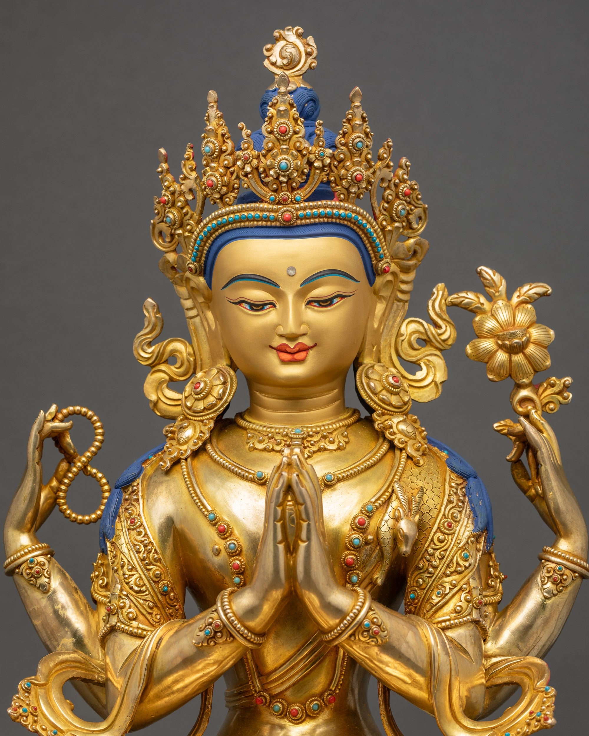 Chenrezig Statue close up gold-gilded face with 3D carvings Nepalese art