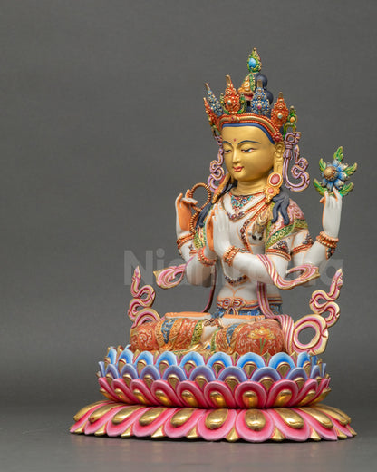 Chenrezig Statue left side view showing four arms holding rosary, lotus, gem