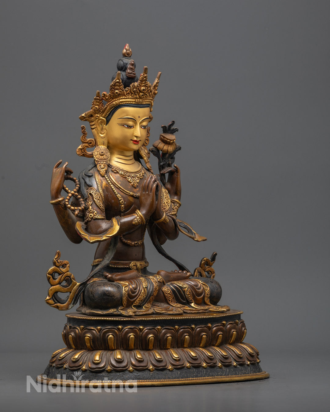 Chenrezig statue holding crystal rosary, utpala flowers, and wish-fulfilling crystain rich acrylic colors