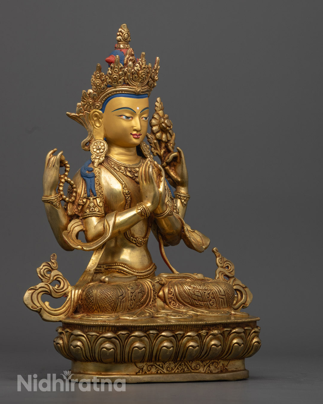 Chenrezig statue’s front hands holding a wish-fulfilling gem (Cintamani) at the heart, symbolizing the unity of wisdom and compassion.