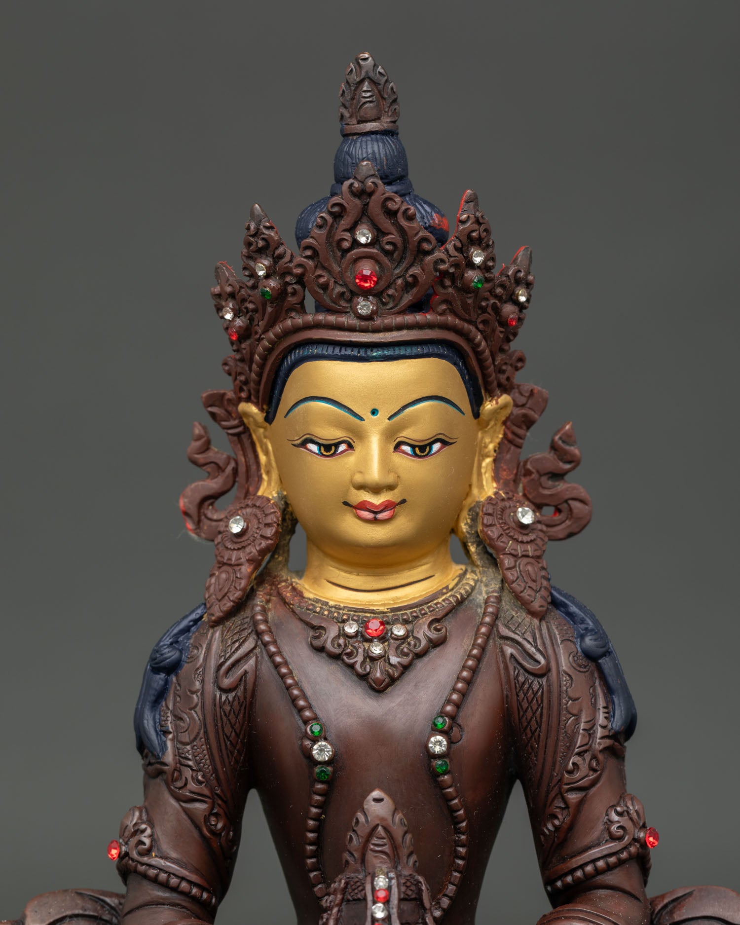 Close Up Amitayus Buddha Statue with Semi Precious Stones and Serene Expression.