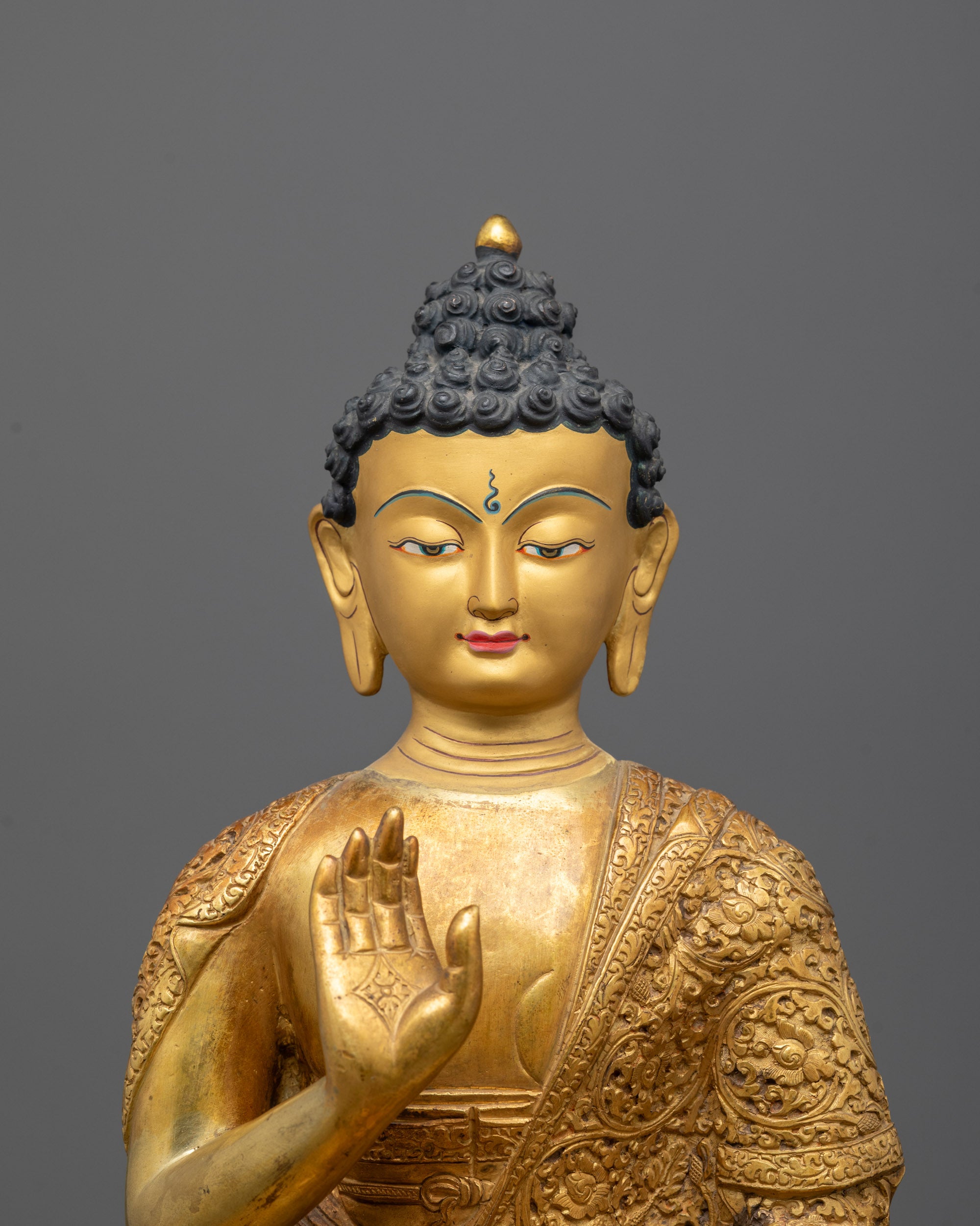 Close-Up of Amoghasiddhi Buddha’s Intricate Gold Detailing and Facial Features