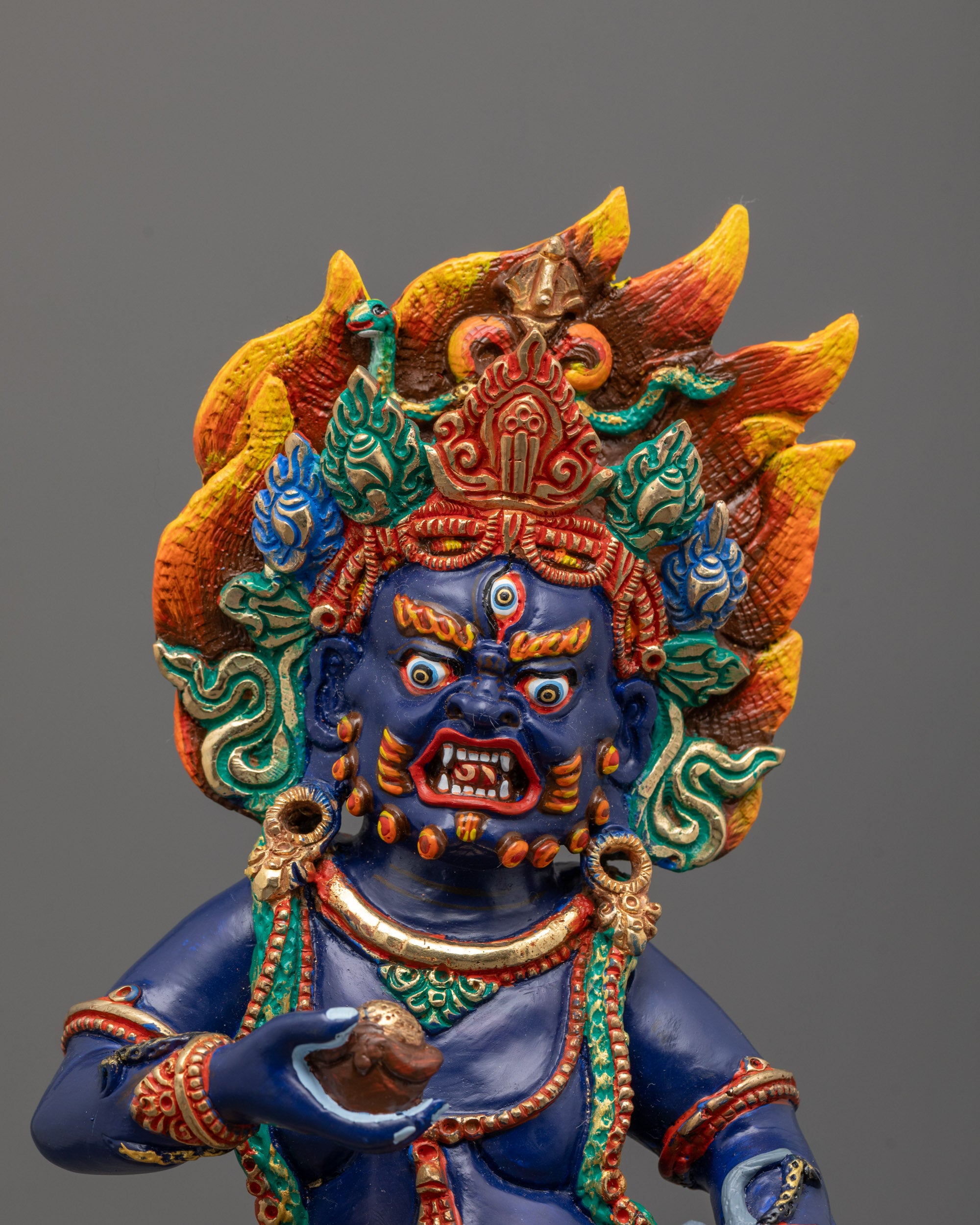Close-Up of Black Dzambhala’s Fierce Expression and Mongoose Holding Detail
