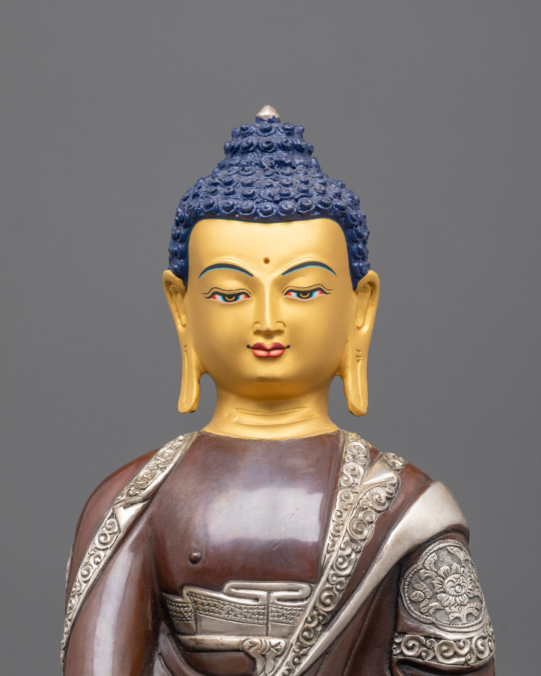 Close-Up of Buddha’s Serene Face with Intricate Gold Gilding and Acrylic Detailing