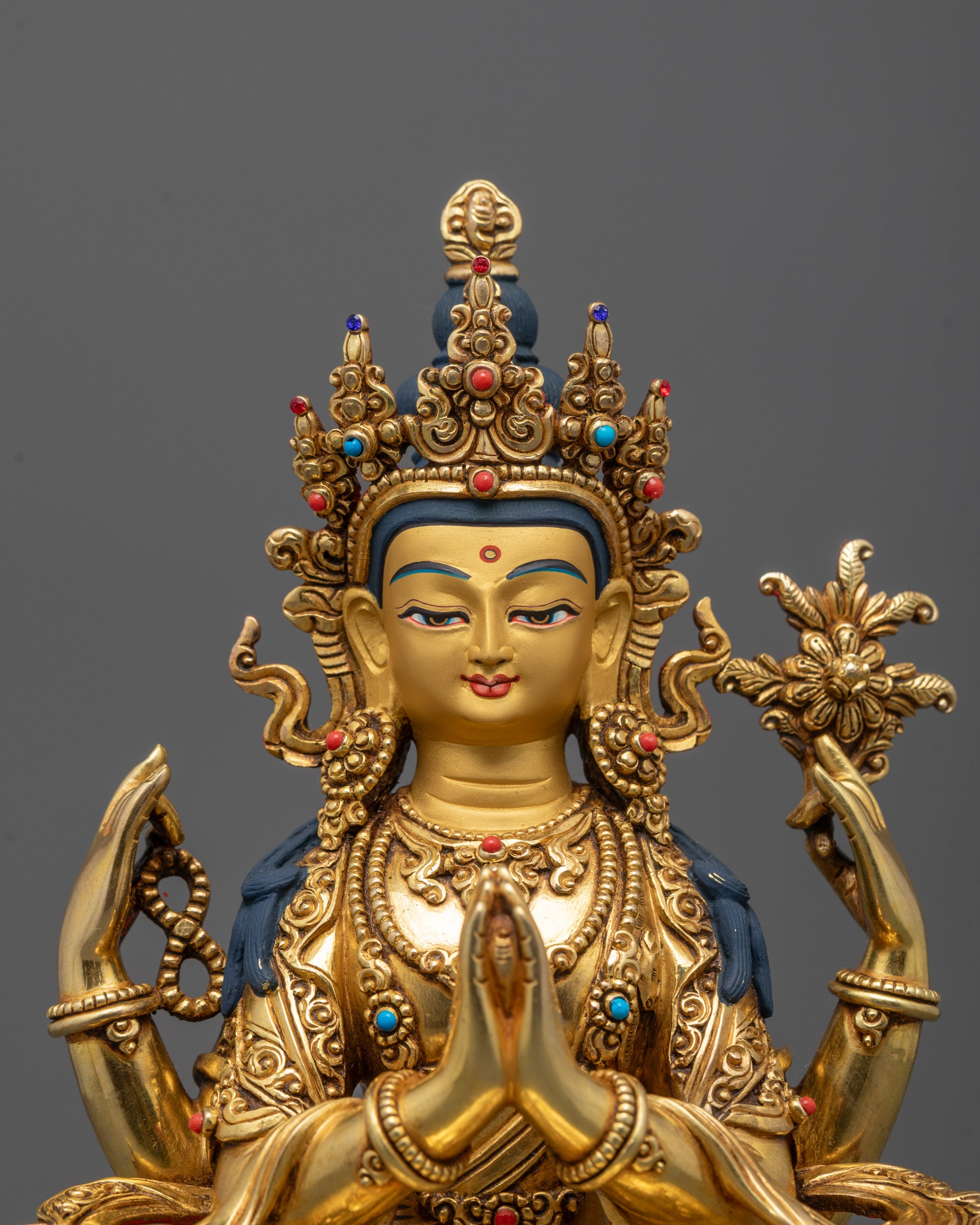 Close-Up of Chenrezig Buddha’s Serene Face and Intricate Gold Detailing