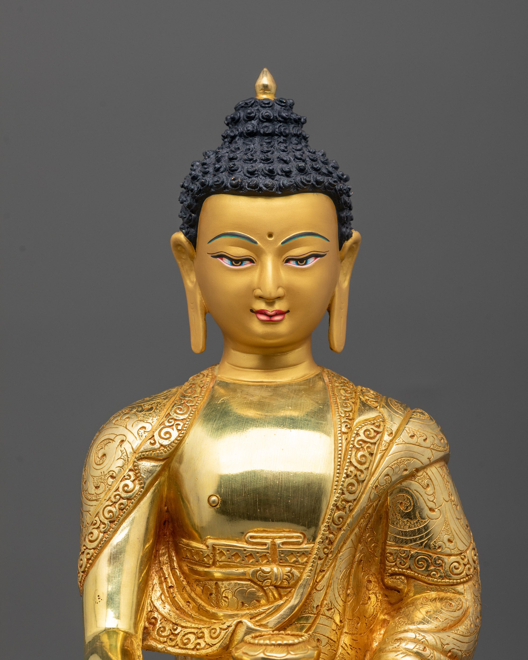 Close-Up of Shakyamuni Buddha Face with 24k Gold Gilding and Peaceful Expression