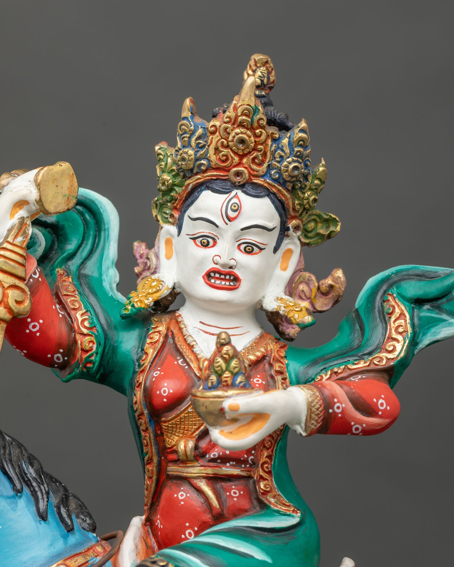 Close up Achi Chokyi Drolma statue, intricate details hand-painted colors