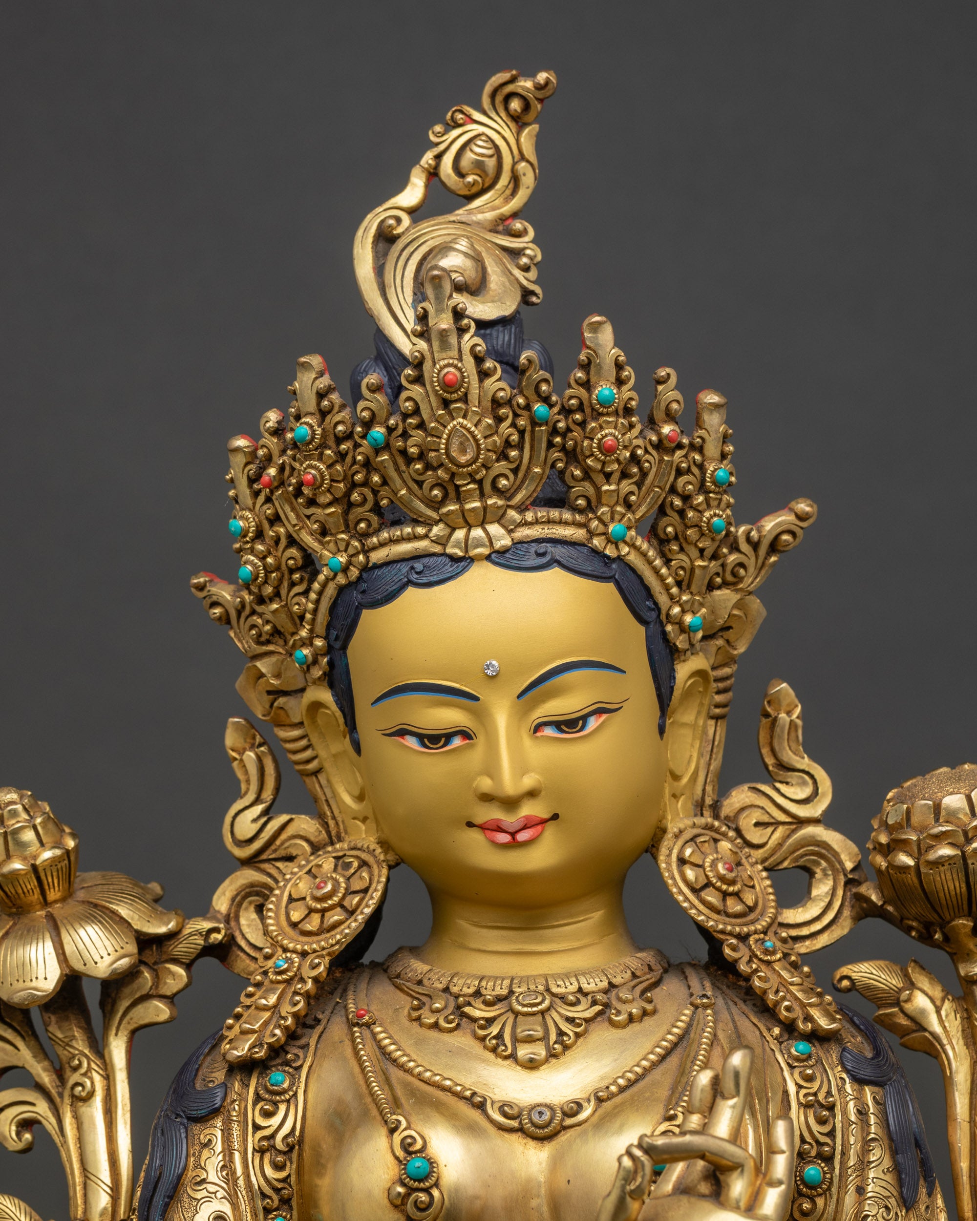 Close-up-Green-Tara-face-gold-painted-serene-expression-semi-precious-stone-inlays