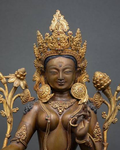 Close-up Green Tara statue, oxidized copper texture, crown and jewelry details