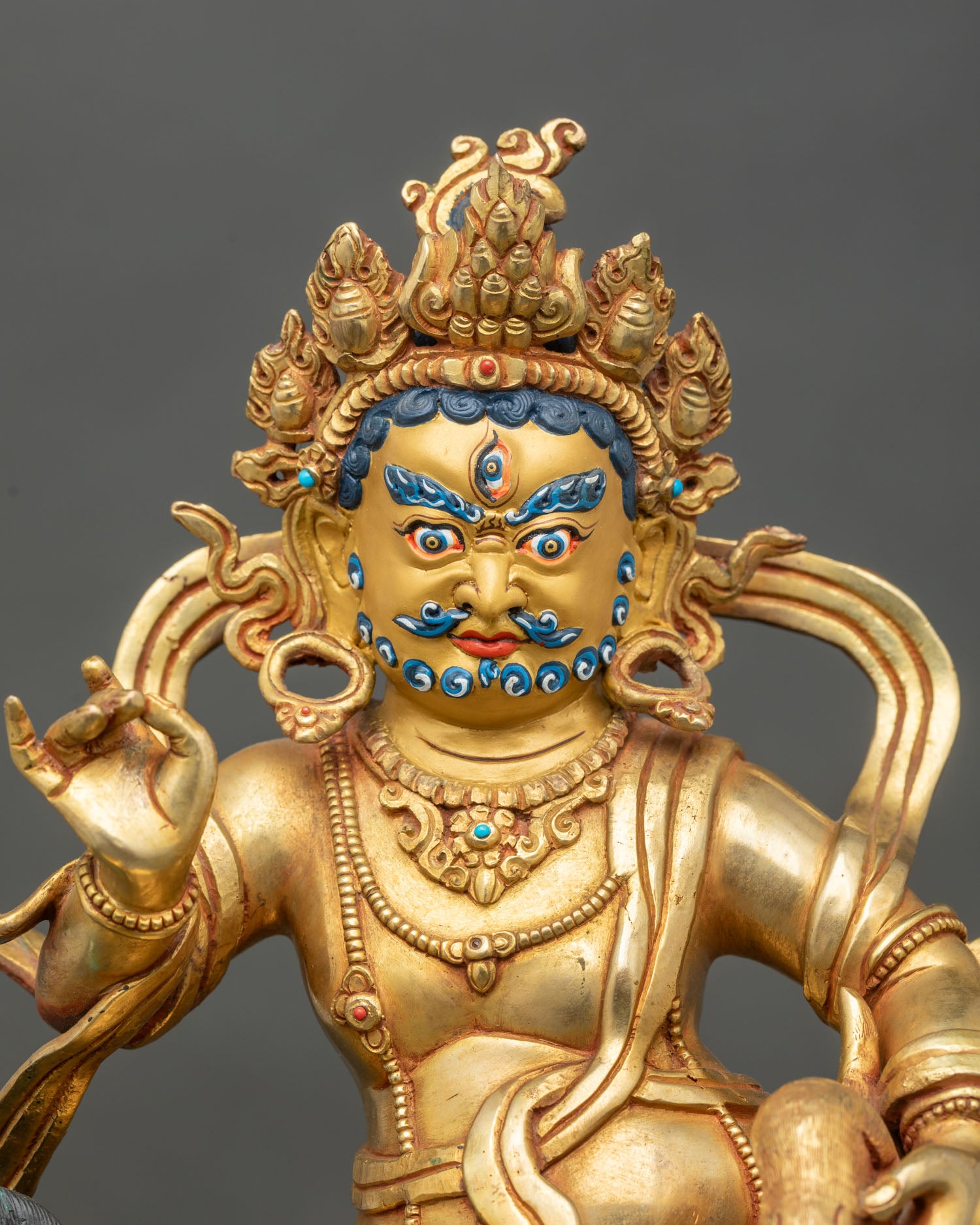 Close up Namtoshe gold-gilded face intricate carvings hand-set semi-precious stones