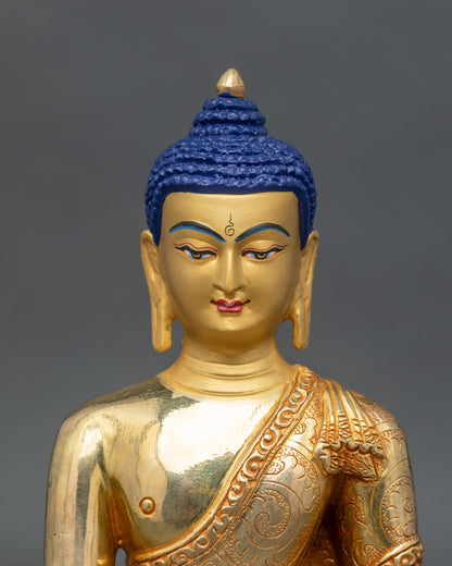 Close up Shakyamuni Buddha statue – serene gold painted face with floral motifs