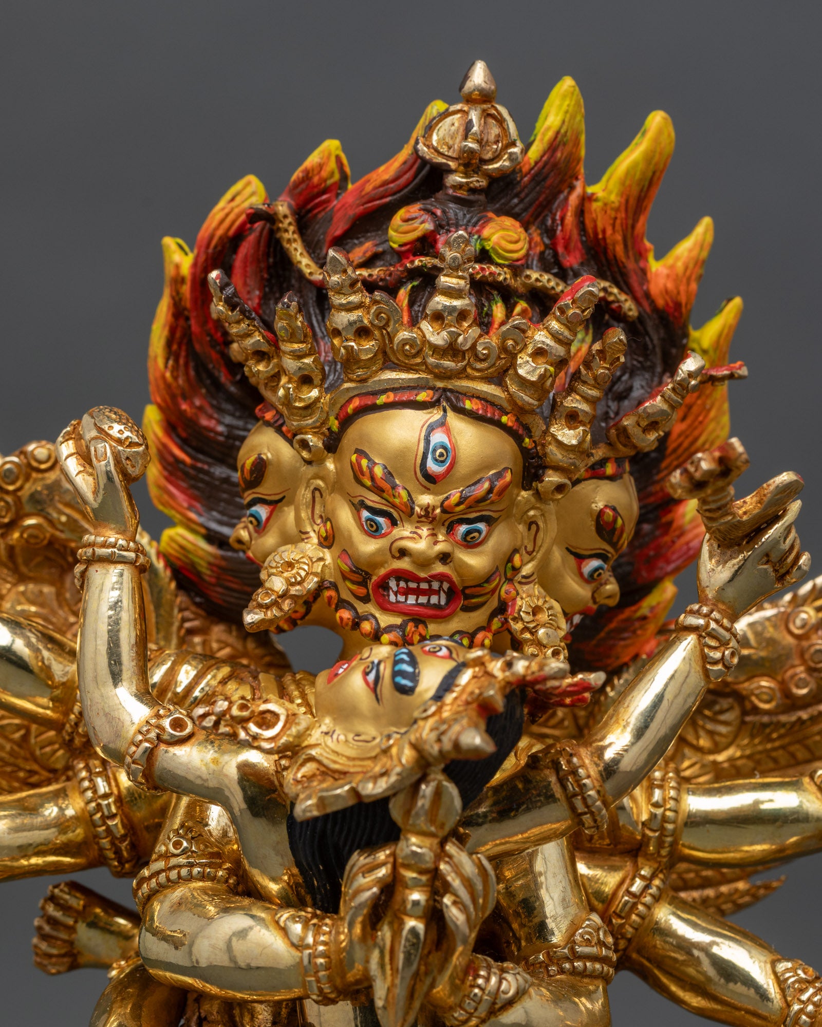 Close up View of Vajrakilaya face gold-painted intricate details Nepalese Buddhist tantric deity